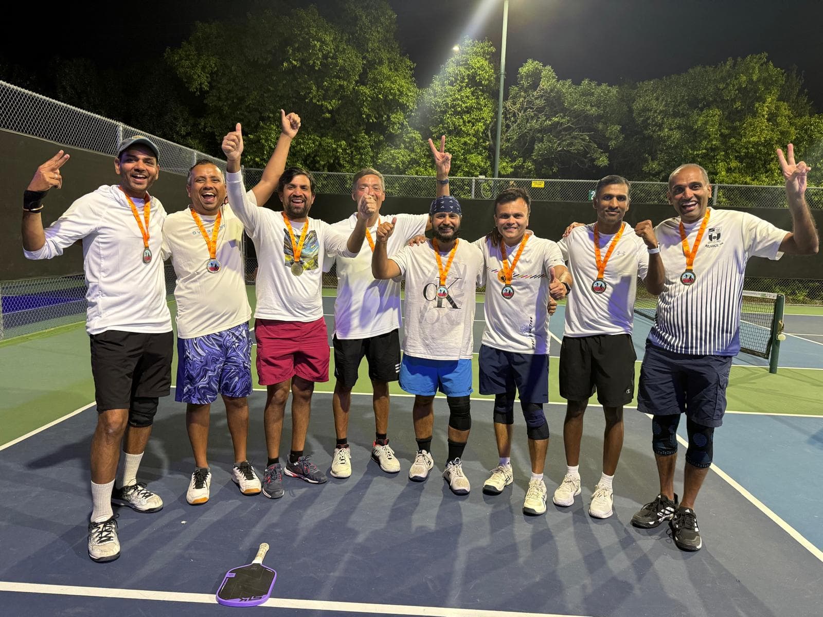 Champions of the 10th Cambrian Pickleball Tournament celebrating together on court.